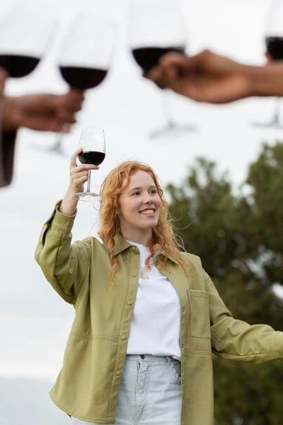 Friends toasting with glasses of wine during outdoor party Friends toasting with glasses of wine during outdoor party